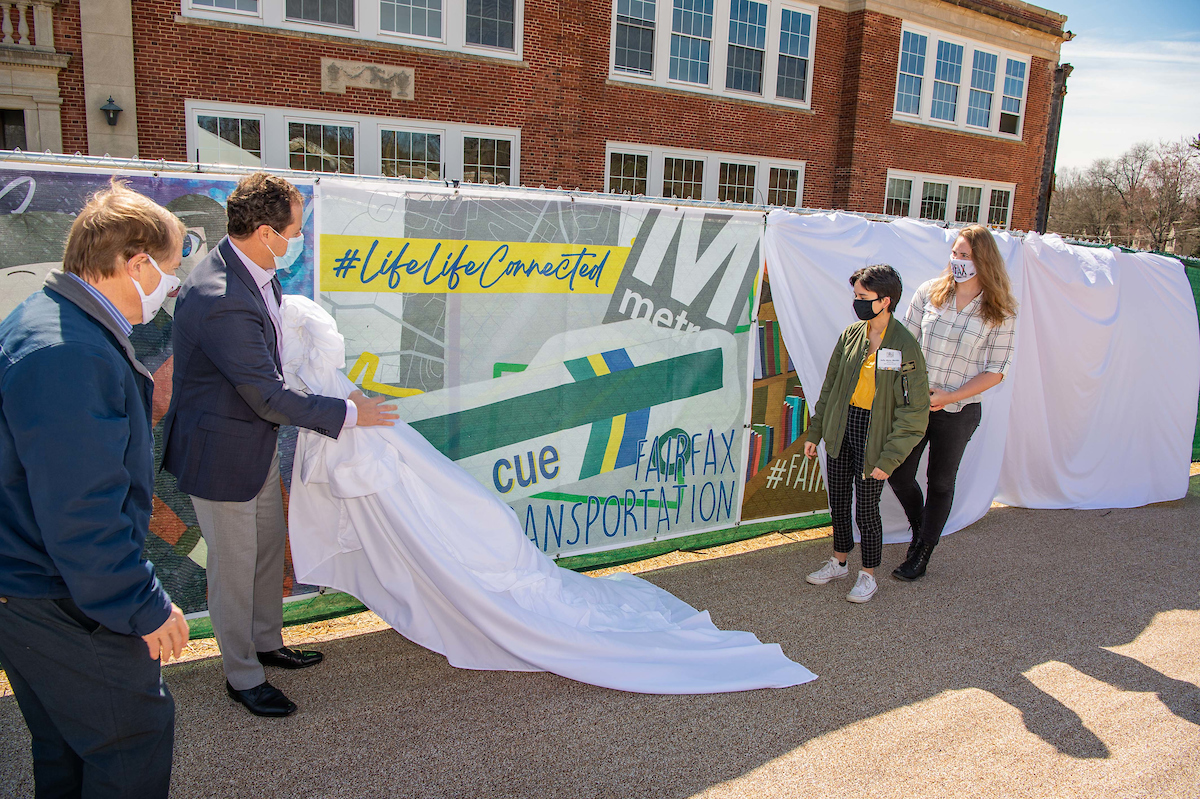 Mayor David Meyer, Enrico Cecchi, student Sofia Mesa-Morales and Mrs. PJ Naber unveiling Sofia Mesa-Morales' piece, "#Transportation."