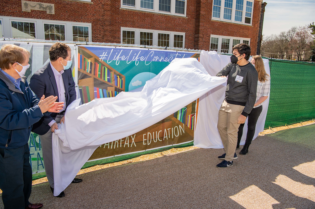 Mayor David Meyer, Enrico Cecchi, student Arian Assadzadeh and Mrs. PJ Naber unveiling Arian Assadzadeh's piece, "#Education."